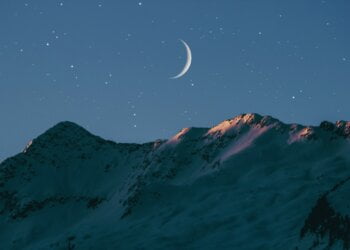 crescent moon above mountain
