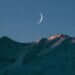 crescent moon above mountain