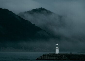 a lighthouse in the middle of a body of water