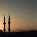 two mosque minarets under calm sky