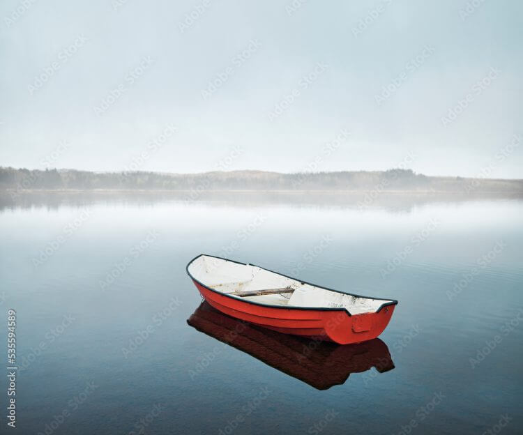 Boat floating on calm lake