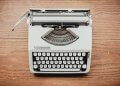 white and black typewriter on table